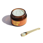 A jar of Solterra Tallow Balm with a sleek gold spoon, highlighting the indulgent, spa-like experience of this rich, regenerative face balm